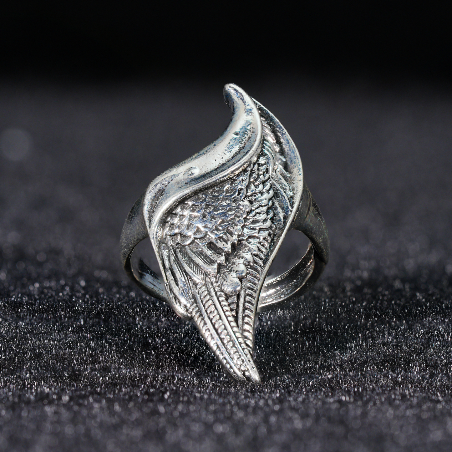 Wing shaped gothic ring with dynamic curves, feathered statement band, mystical guardian style, ideal for bold outfits & symbolic styling