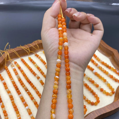 Facettierte orange Achatperlen für DIY Schmuckherstellung, runde geschnittene Edelsteine, banded Muster, ca. 6mm, Strang ca. 38cm