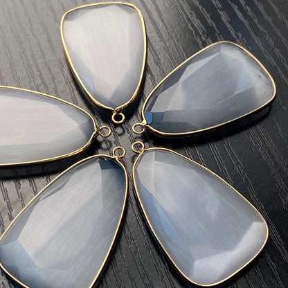 Facettierter grauer synthetischer Katzenauge Kristall Anhänger mit goldfarbener Fassung für DIY Schmuckherstellung und Boho Schmuckdesign